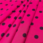 Tela lunares flamencos base fucsia con lunares negros